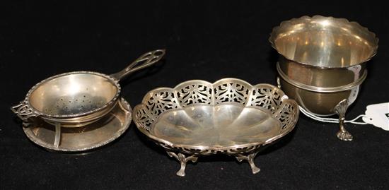 A silver tea strainer, a silver sugar bowl and a silver bon bon dish.